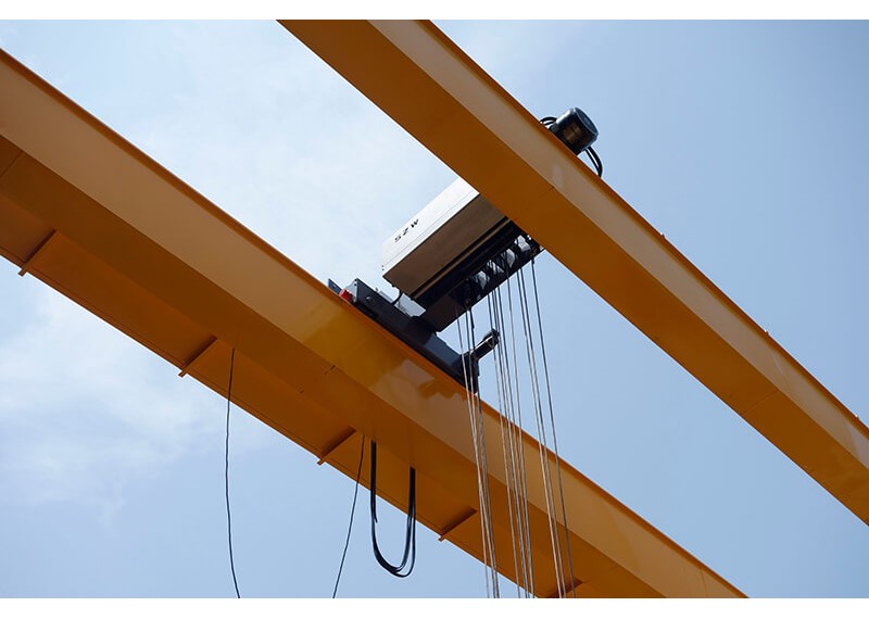 What are the main uses and common dangers of double beam grab cranes?